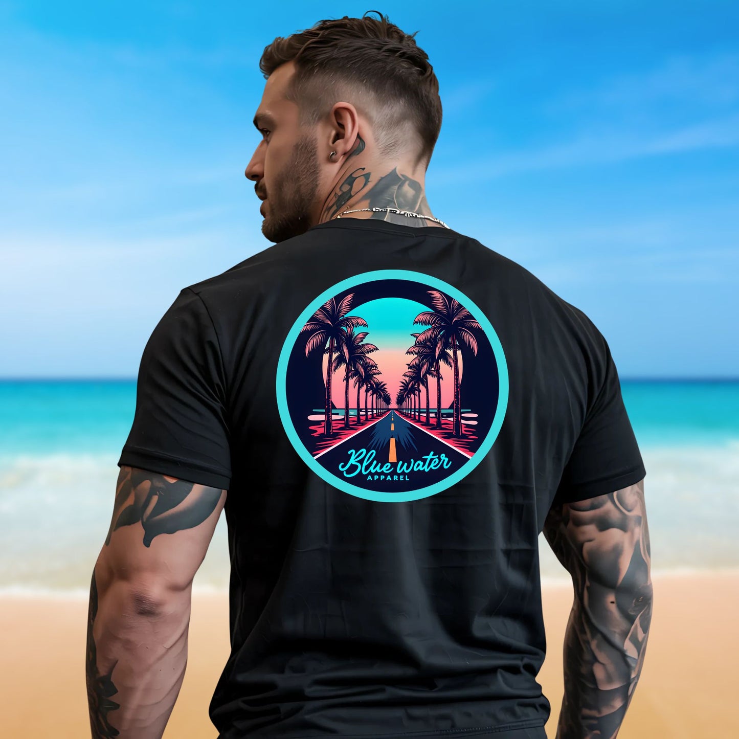 male model on beach wearing black palm tree road tee by blue water apparel