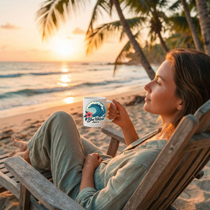 woman holding the hibiscus wave coffee mug sitting in chair on sunrise beach by blue water apparel