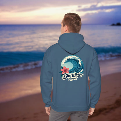 male model on beach wearing indigo blue hibiscus wave hoodie by blue water apparel