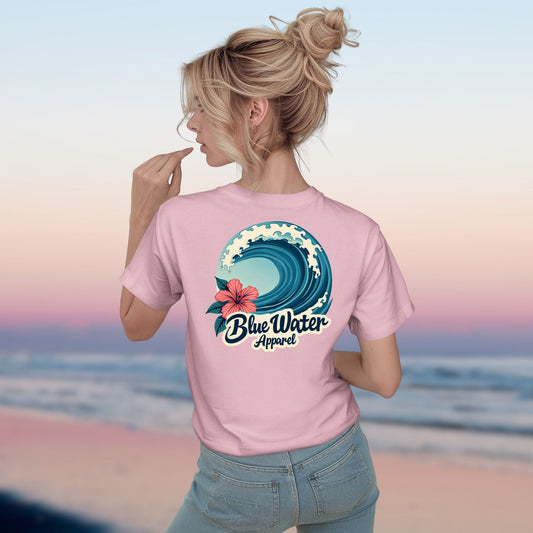 Woman model wearing pink hibiscus wave tee by blue water apparel
