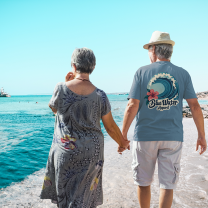 man and woman walking on beach man wearing steel blue hibiscus wave tee by blue water apparel