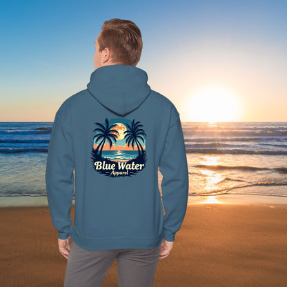 Man on beach wearing indigo blue tropical moon hoodie by blue water apparel