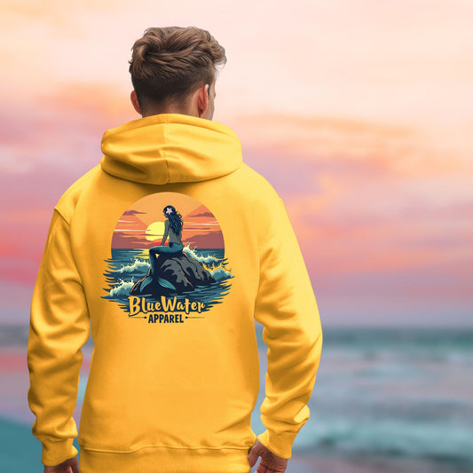 man on beach wearing gold mermaid sunset hoodie by blue water apparel