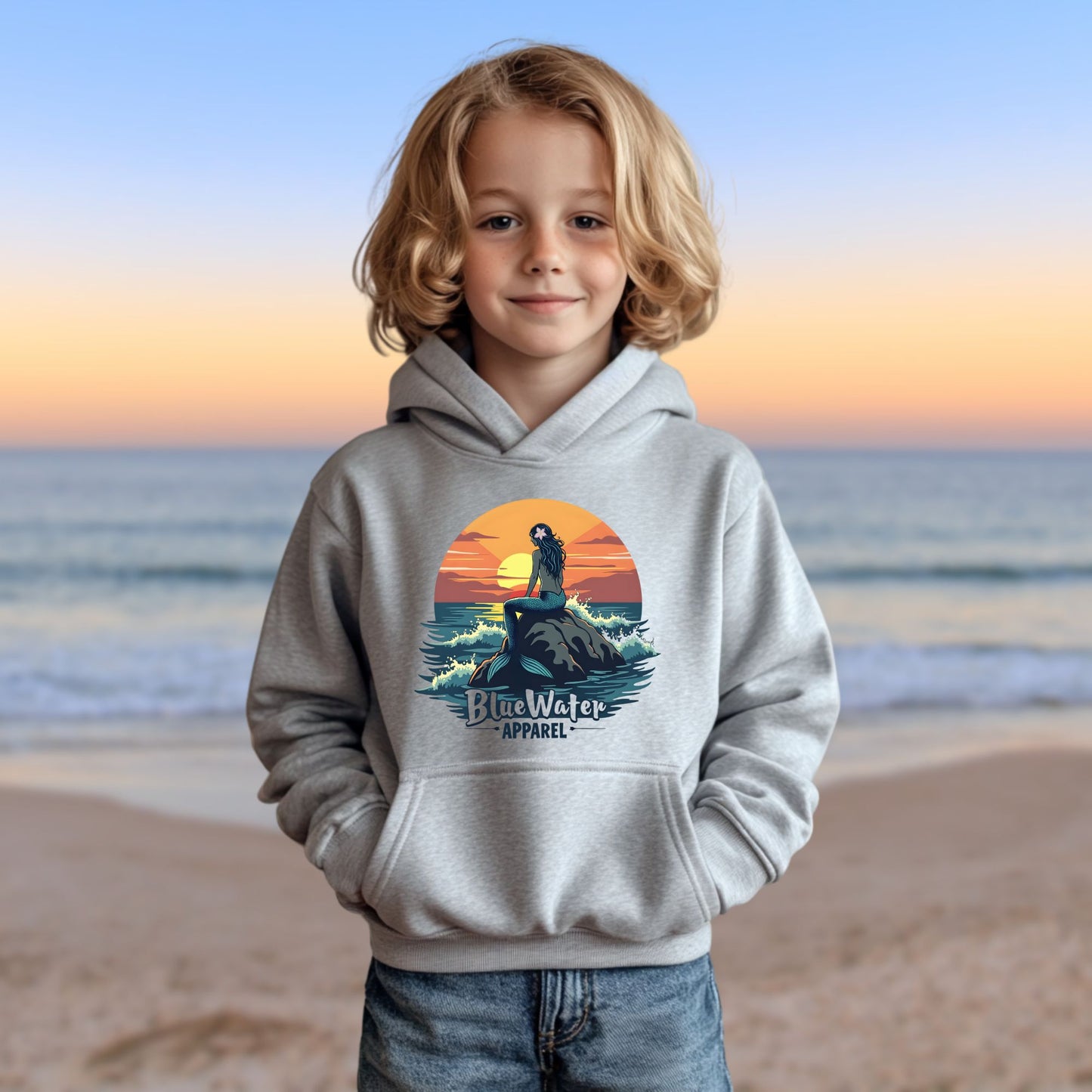 child model on beach wearing sport grey mermaid sunset kids hoodie by blue water apparel