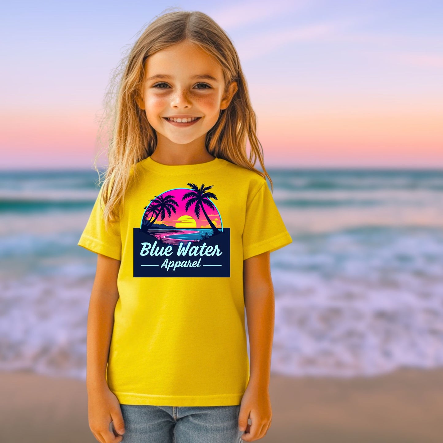 girl on beach wearing daisy neon sunset tee by blue water apparel