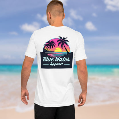 man on beach wearing white neon sunset tee by blue water apparel