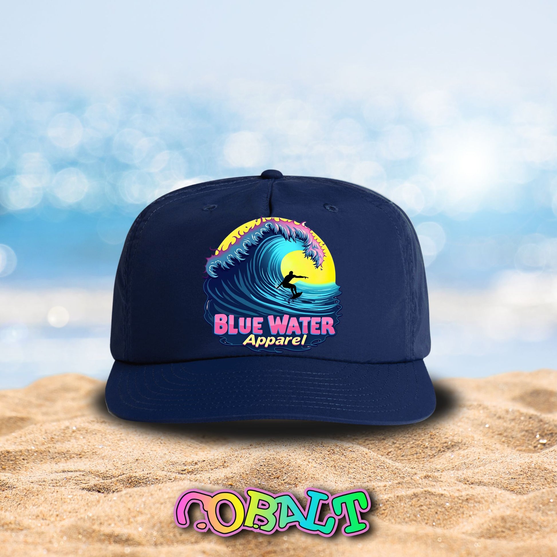 neon surfer cobalt surf cap sitting on beach by blue water apparel