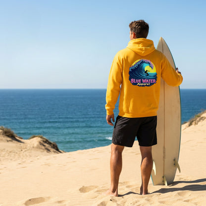 model wearing gold neon surfer adult hoodie standing on beach with surfboard by blue water apparel