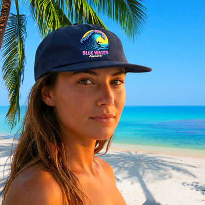 woman wearing cobalt neon surfer surf cap on tropical beach by blue water apparel