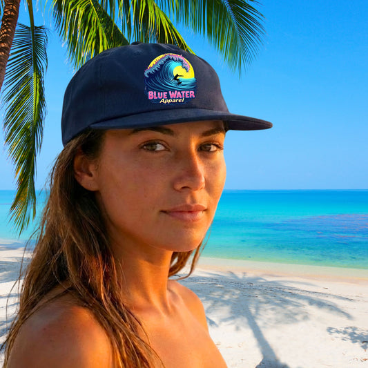 woman wearing cobalt neon surfer surf cap on tropical beach by blue water apparel