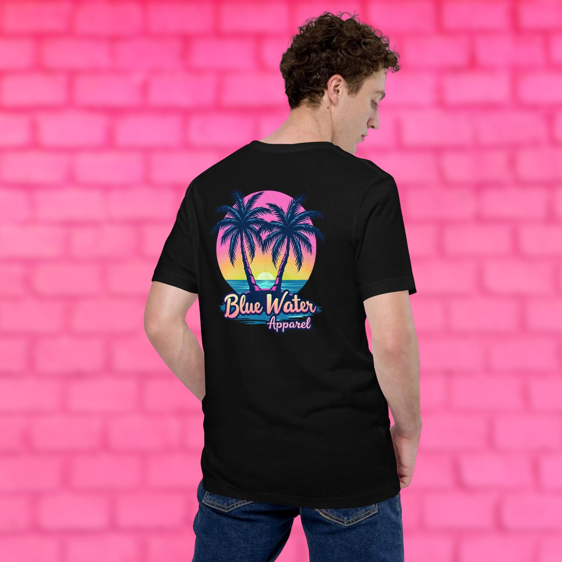 model against pink brick wall wearing black neon tropics tee by blue water apparel