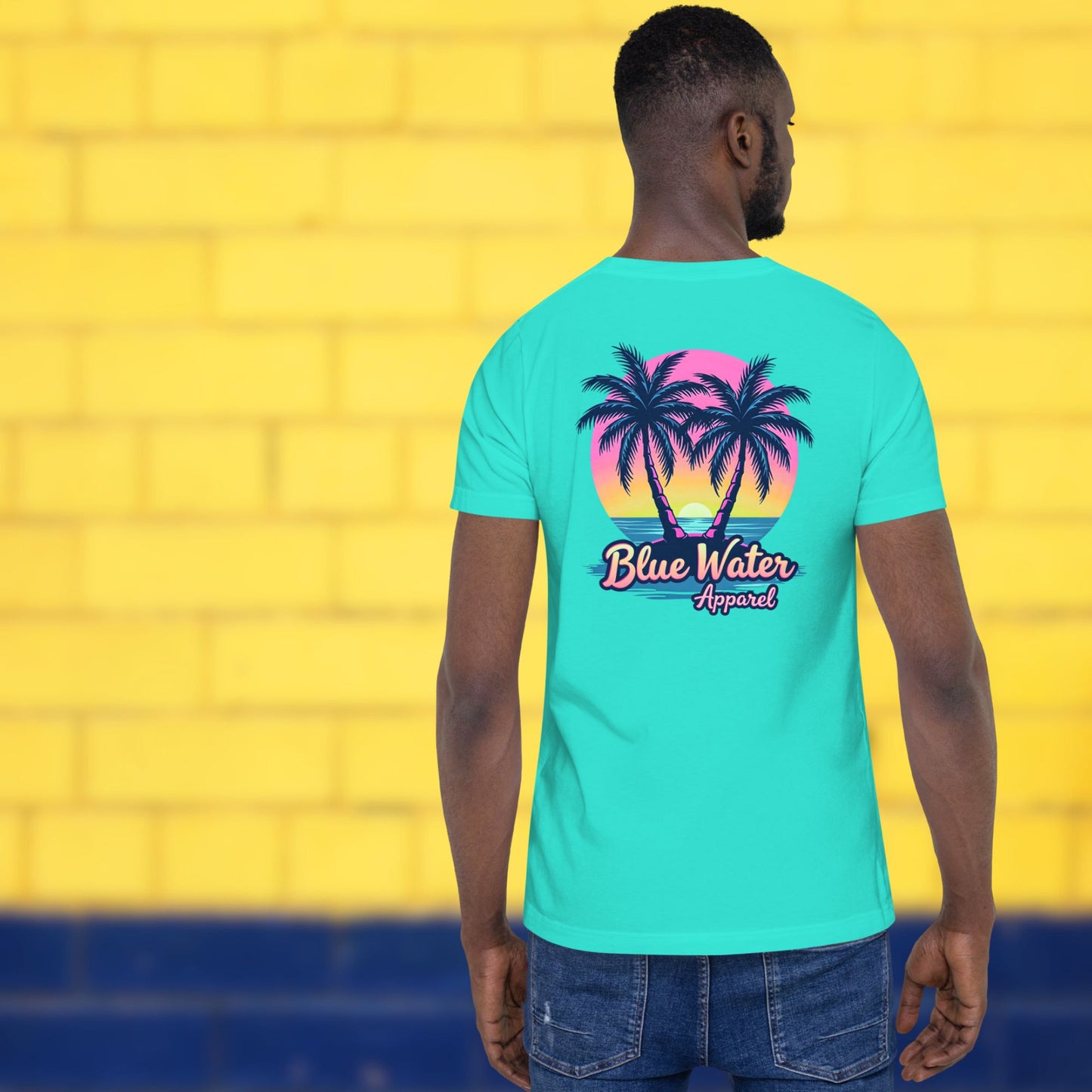 model against yellow brick wall wearing teal neon tropics tee by blue water apparel