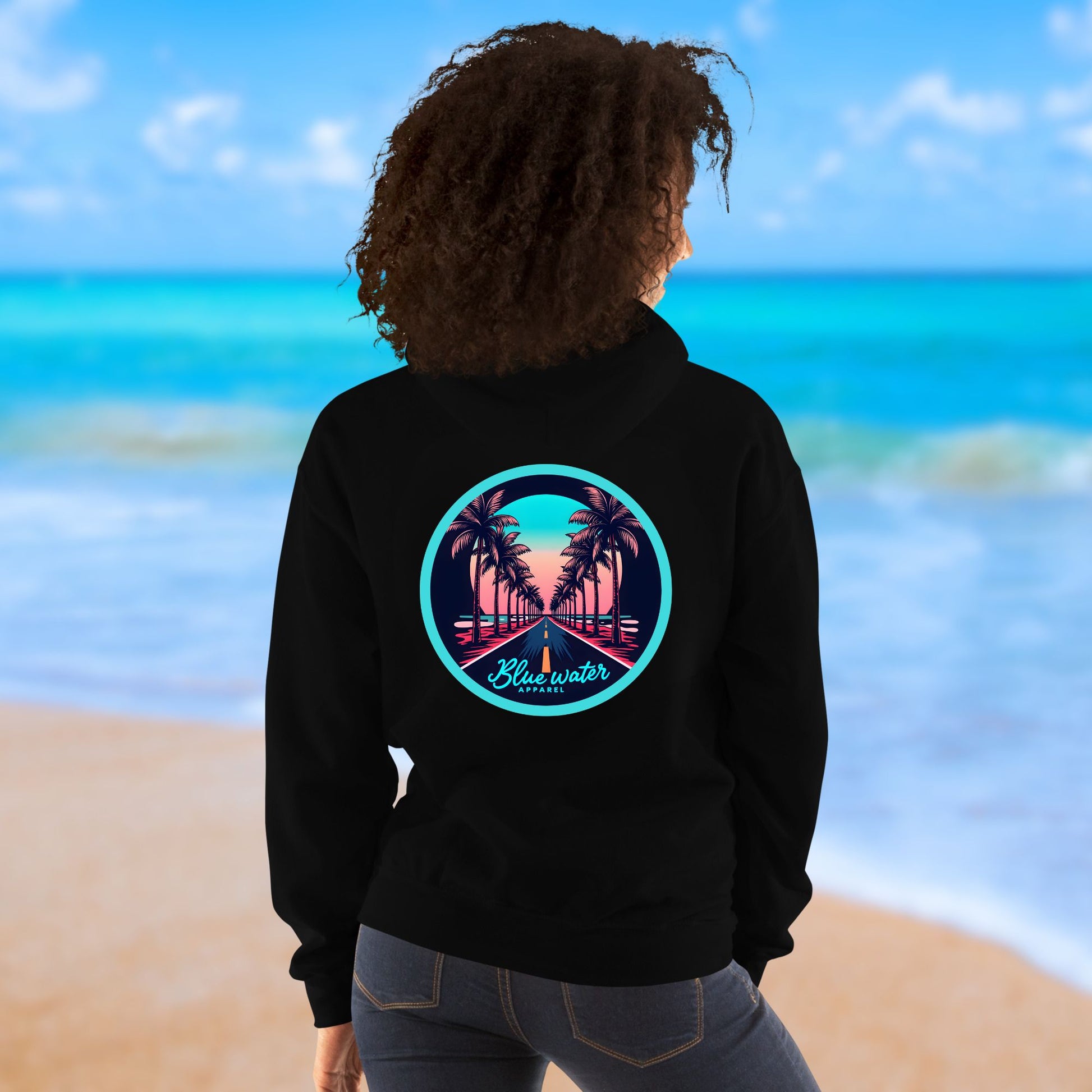 female model on beach wearing black palm tree road hoodie by blue water apparel