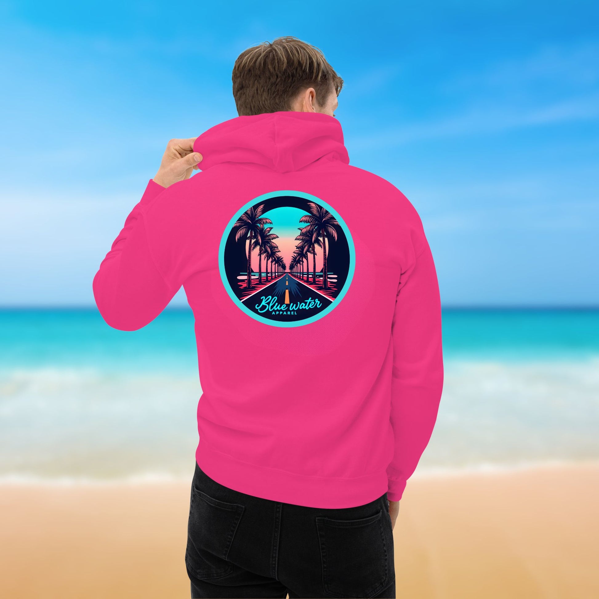 male model on beach wearing heliconia palm tree road hoodie by blue water apparel