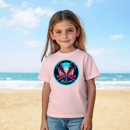 child on beach wearing pink palm tree road tee by blue water apparel