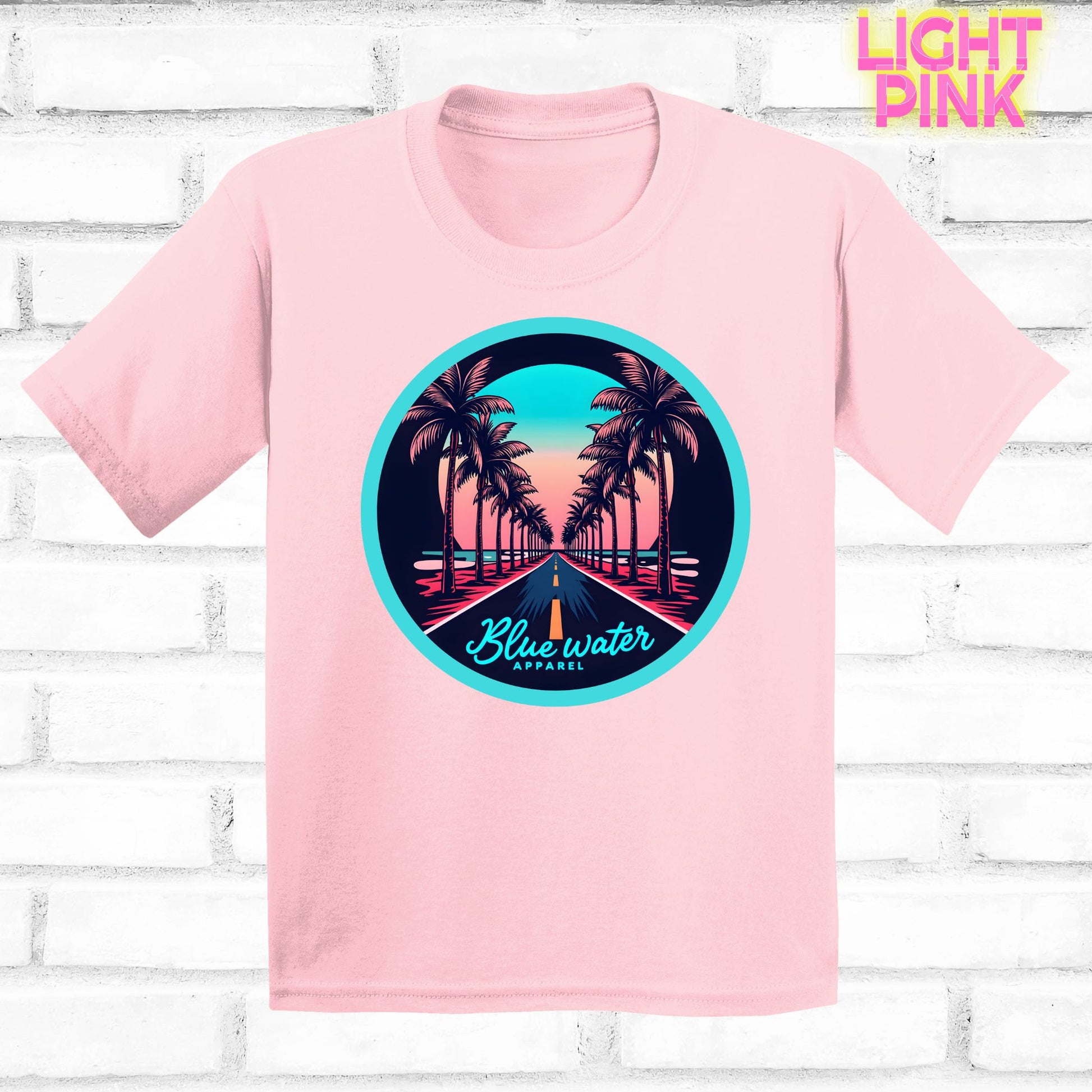 flat lay of light pink palm tree road tee by blue water apparel