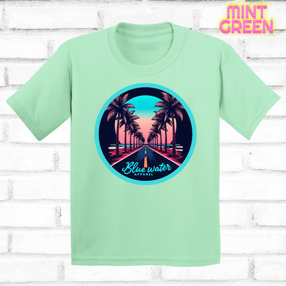 flat lay of mint green palm tree road tee by blue water apparel