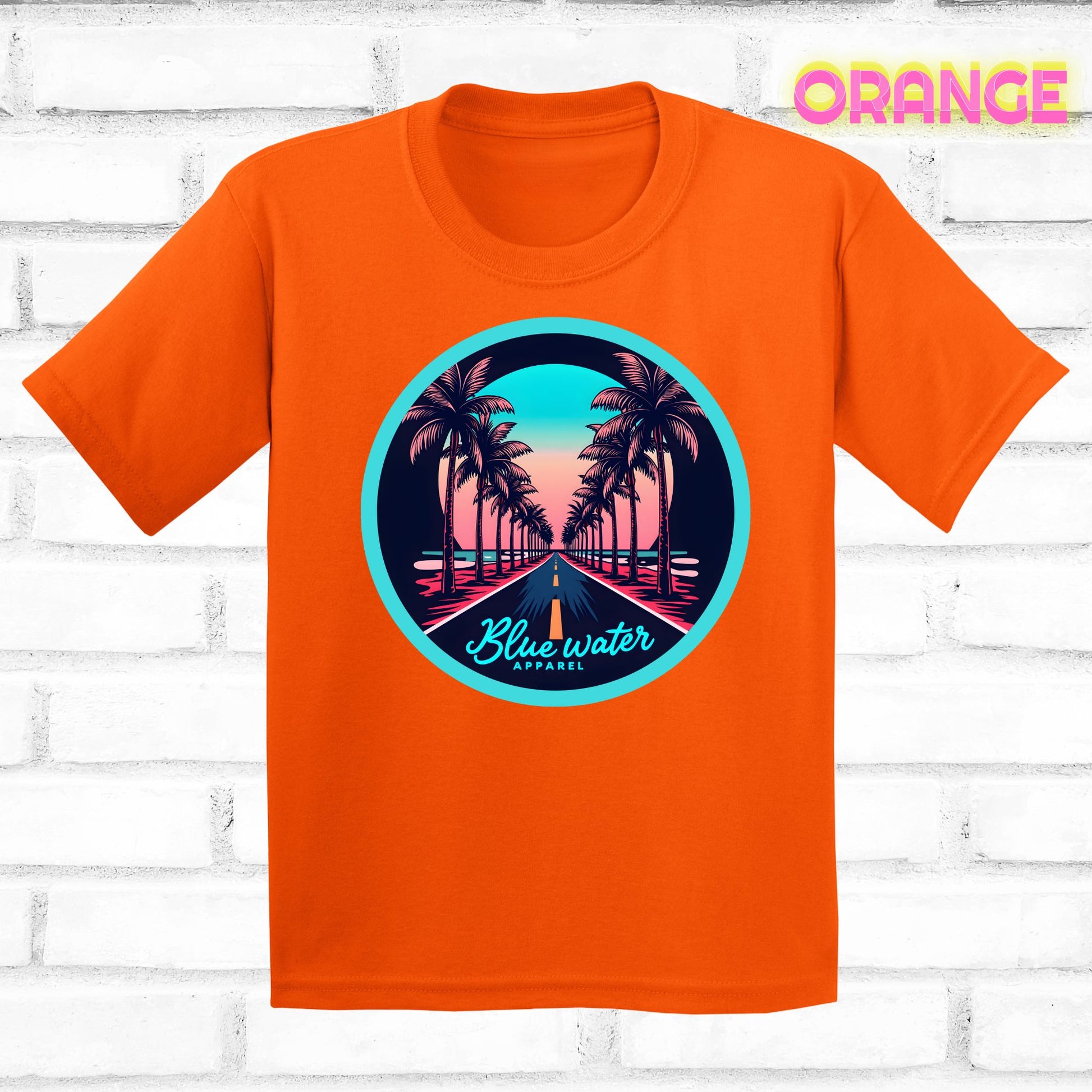flat lay of orange palm tree road tee by blue water apparel
