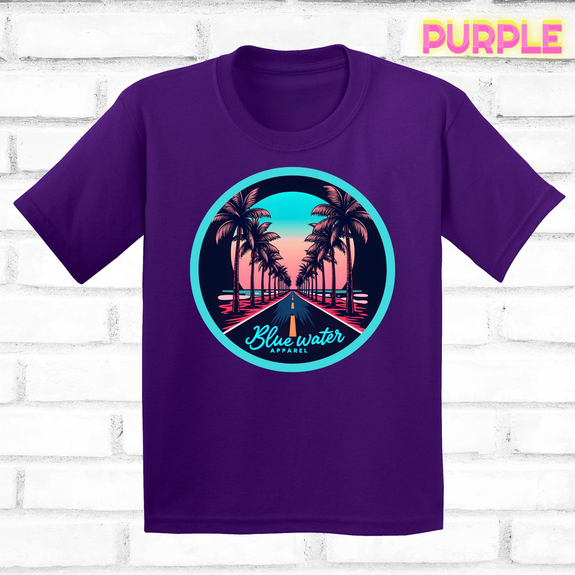 flat lay of team purple palm tree road tee by blue water apparel