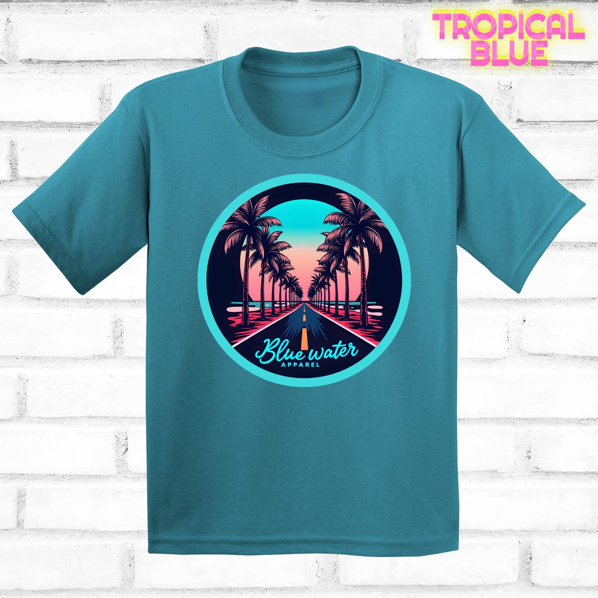 flat lay of tropical blue palm tree road tee by blue water apparel