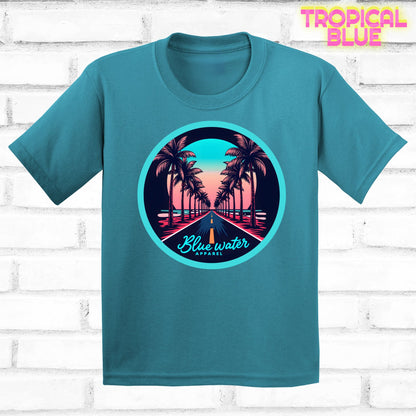 flat lay of tropical blue palm tree road tee by blue water apparel
