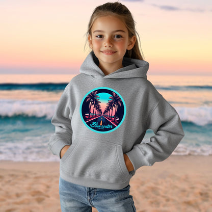 female model on beach wearing sport grey palm tree road kids hoodie by blue water apparel