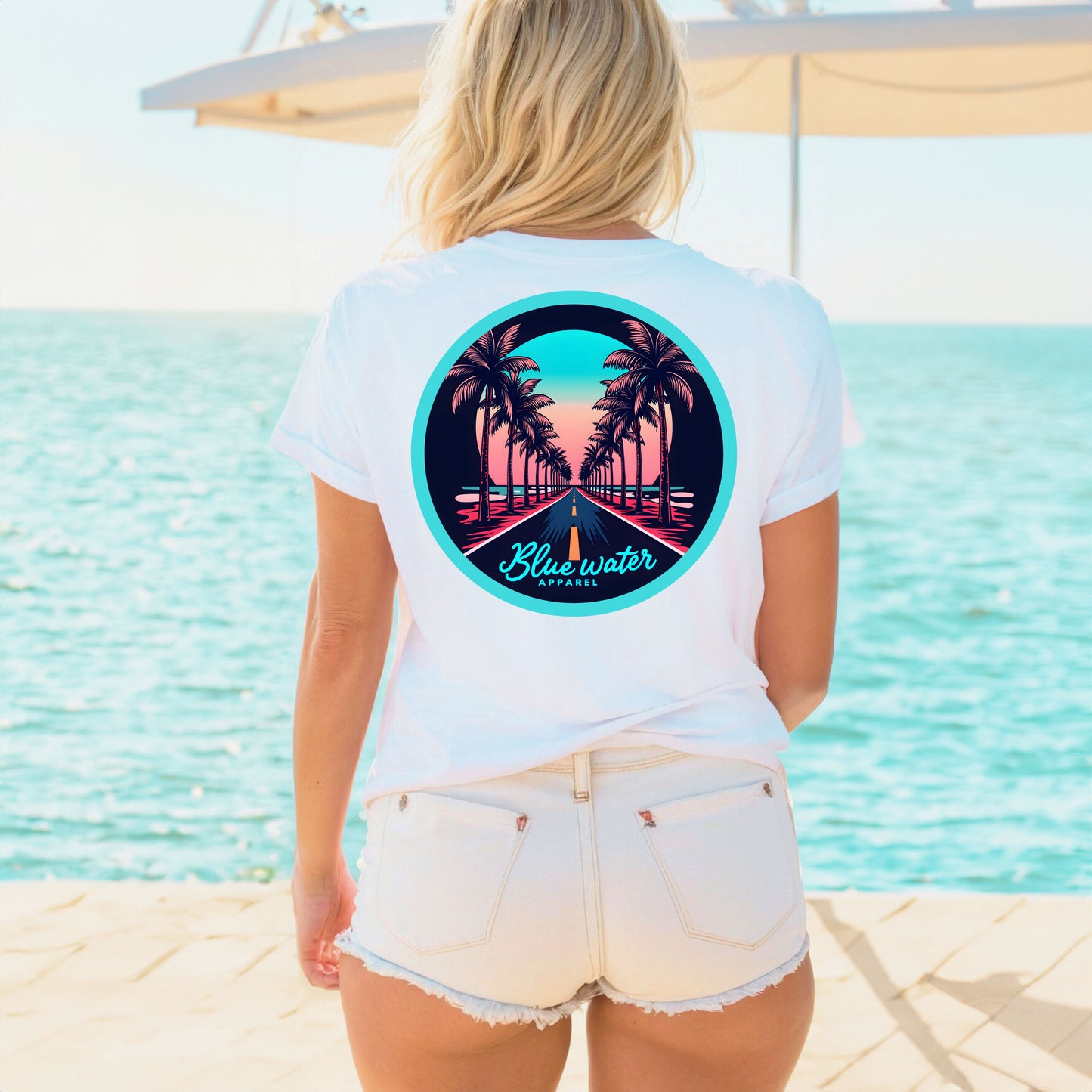 female on boardwalk wearing white palm tree road tee by blue water apparel