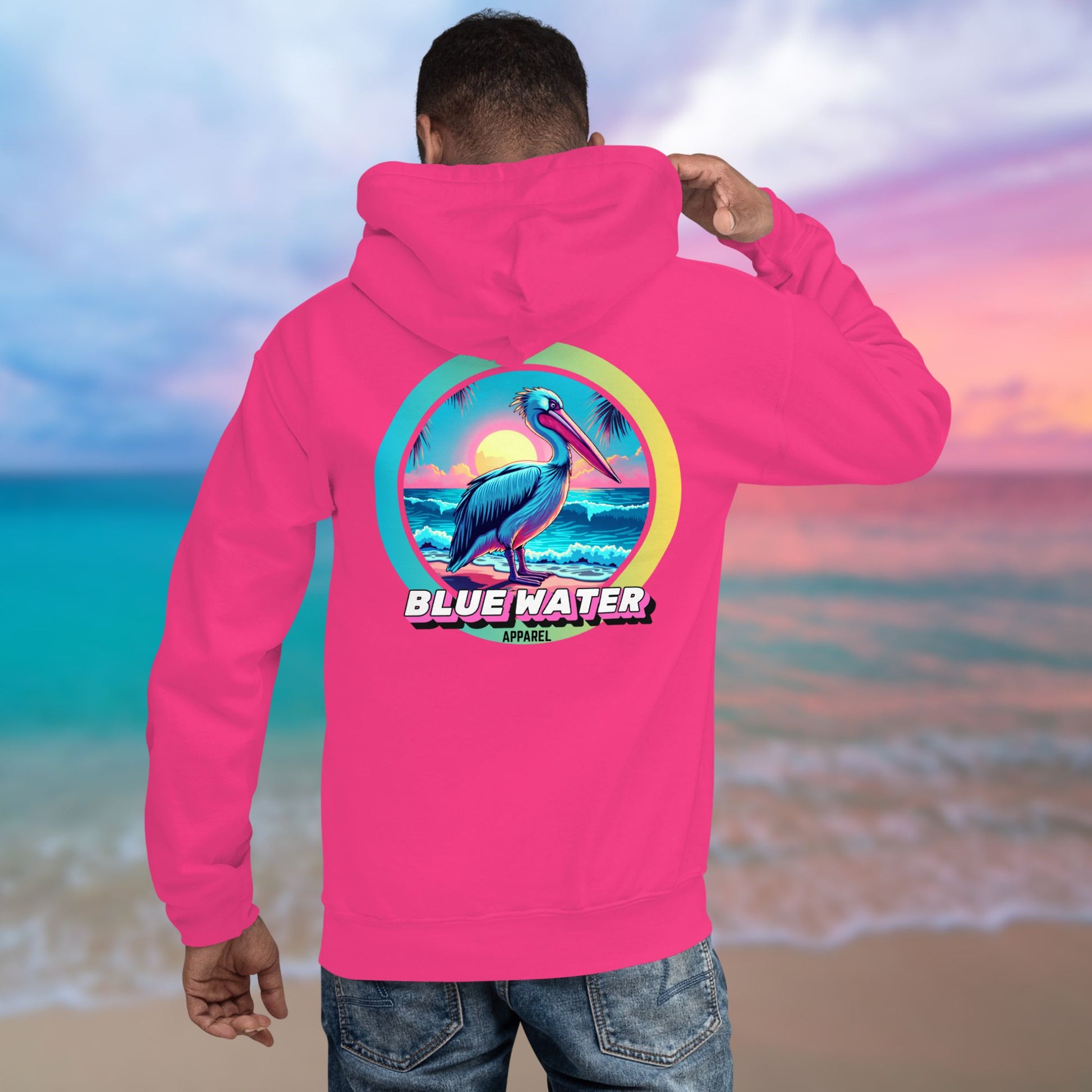 male model on beach wearing heliconia retro pelican hoodie by blue water apparel