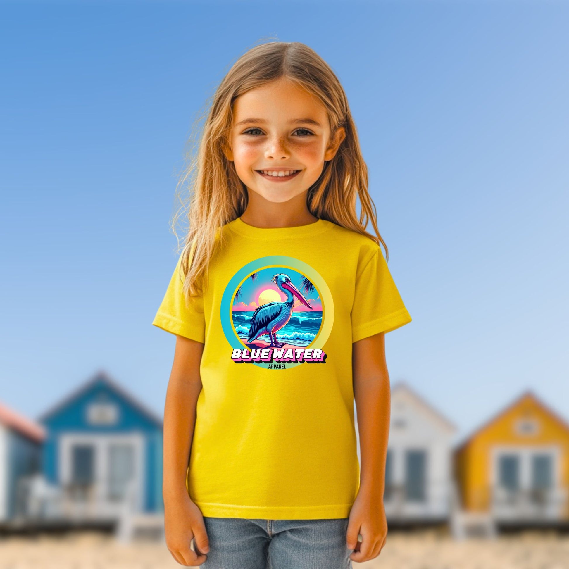 kid model on beach wearing Daisy retro pelican tee by blue water apparel