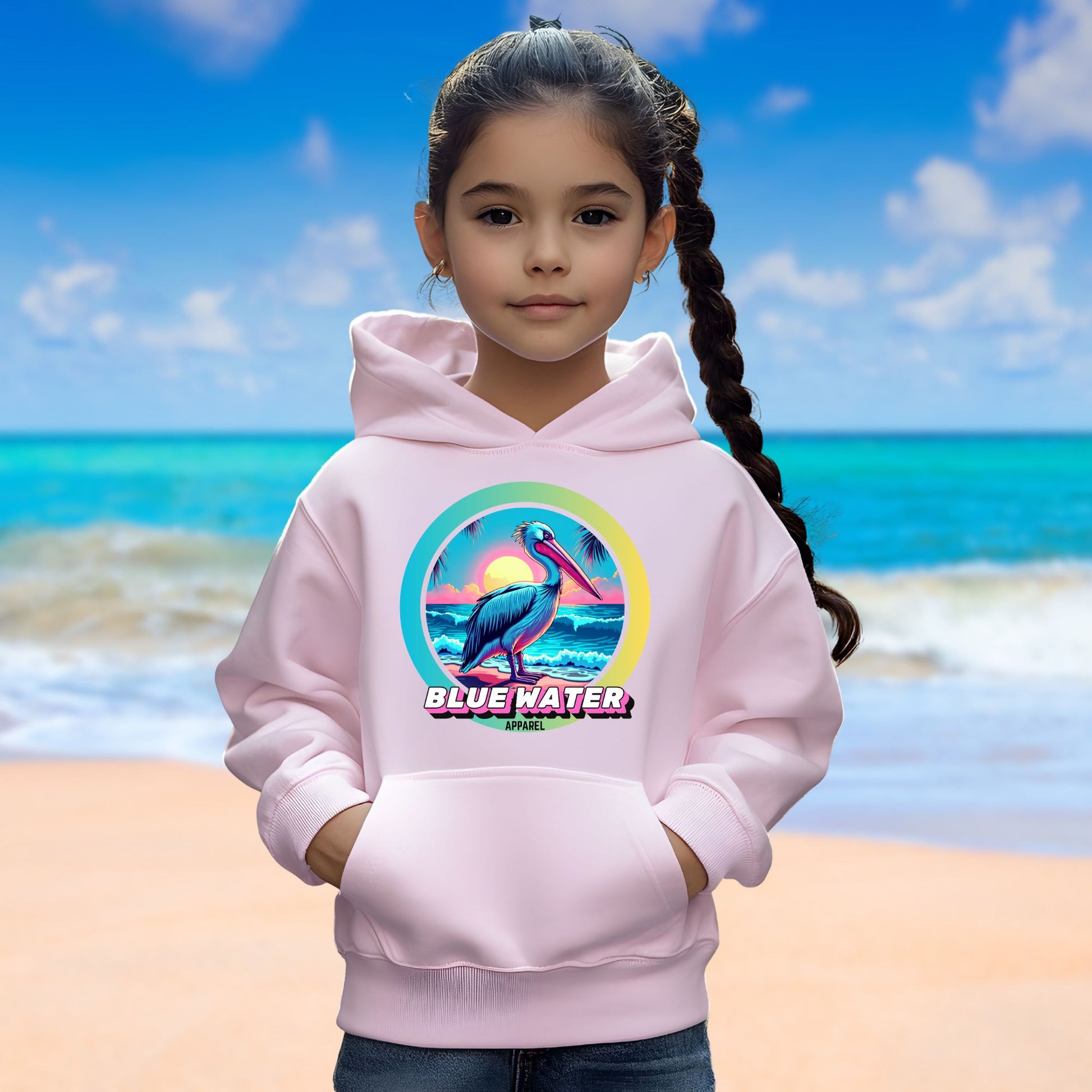 female model on beach wearing light pink retro pelican kids hoodie by blue water apparel