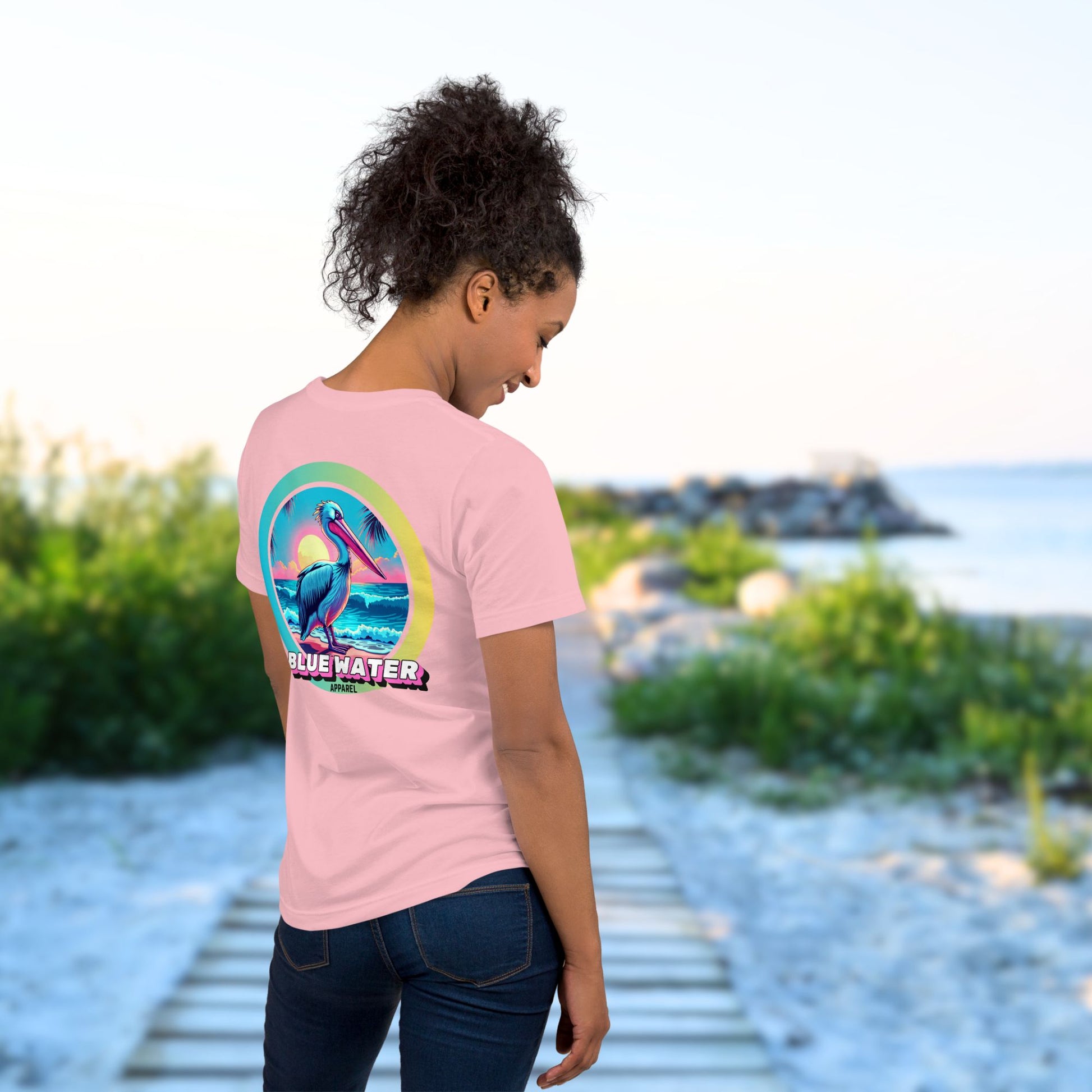 model on boardwalk wearing pink retro pelican tee by blue water apparel