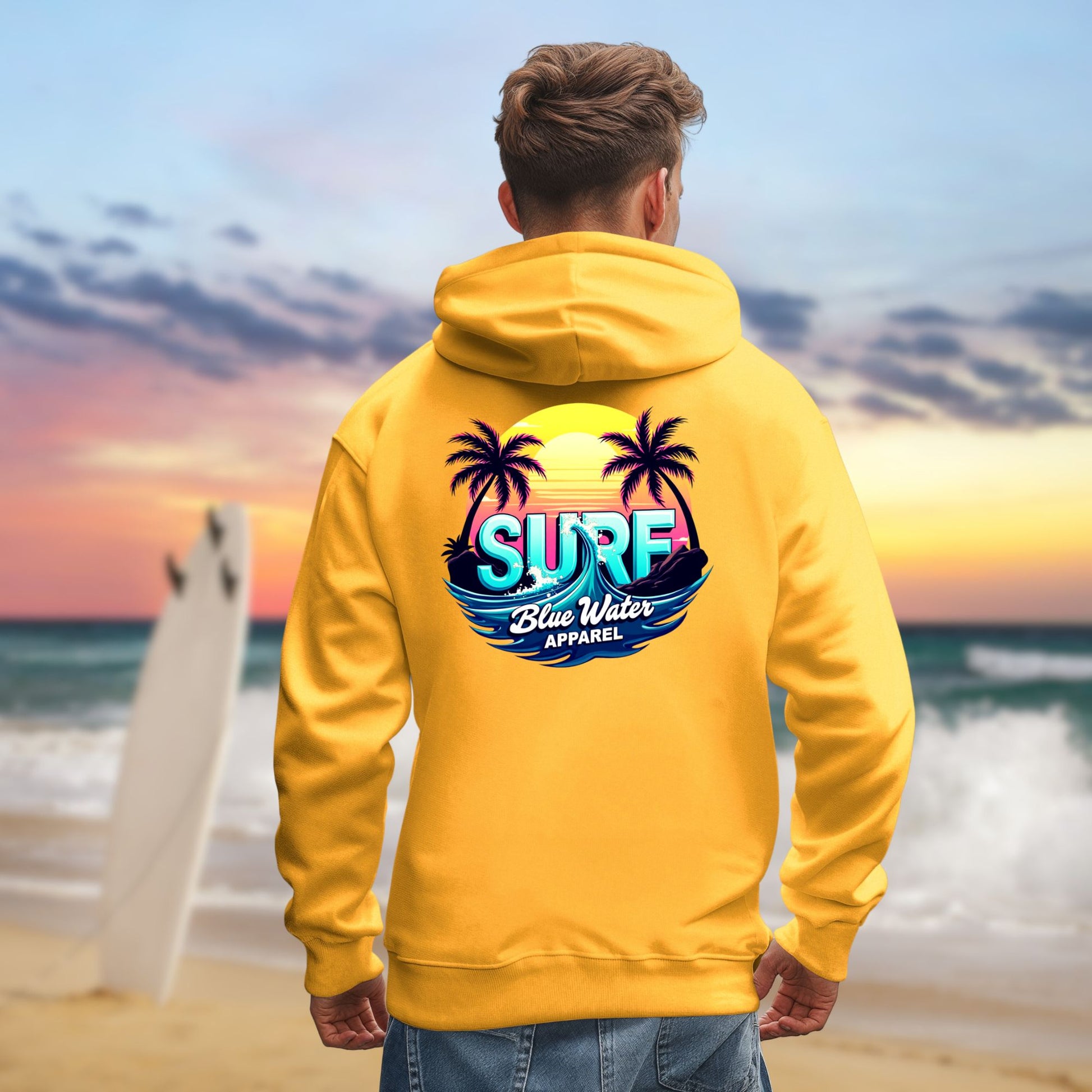man on beach wearing gold retro surf hoodie by blue water apparel