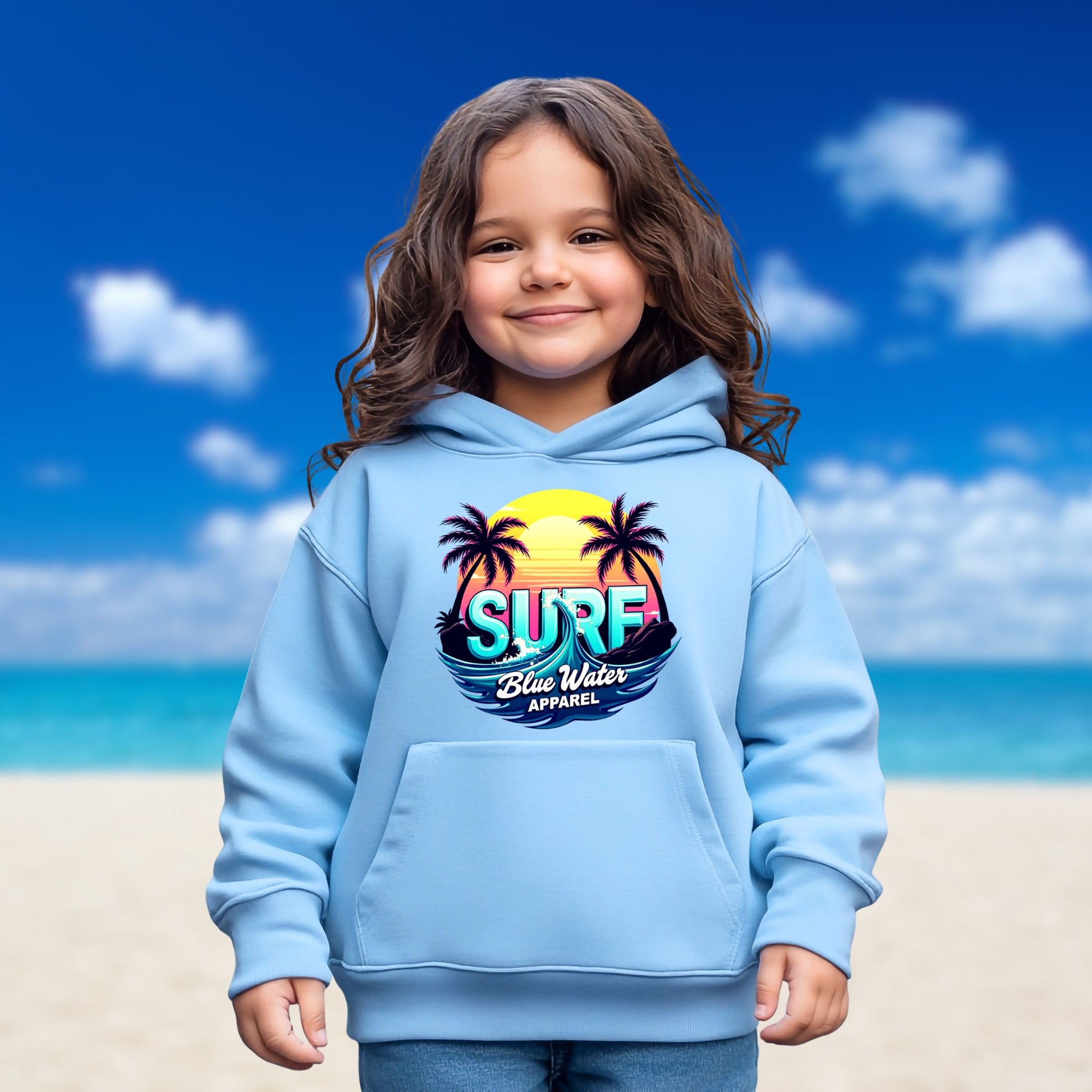 child model on beach wearing carolina blue retro surf kids hoodie by blue water apparel