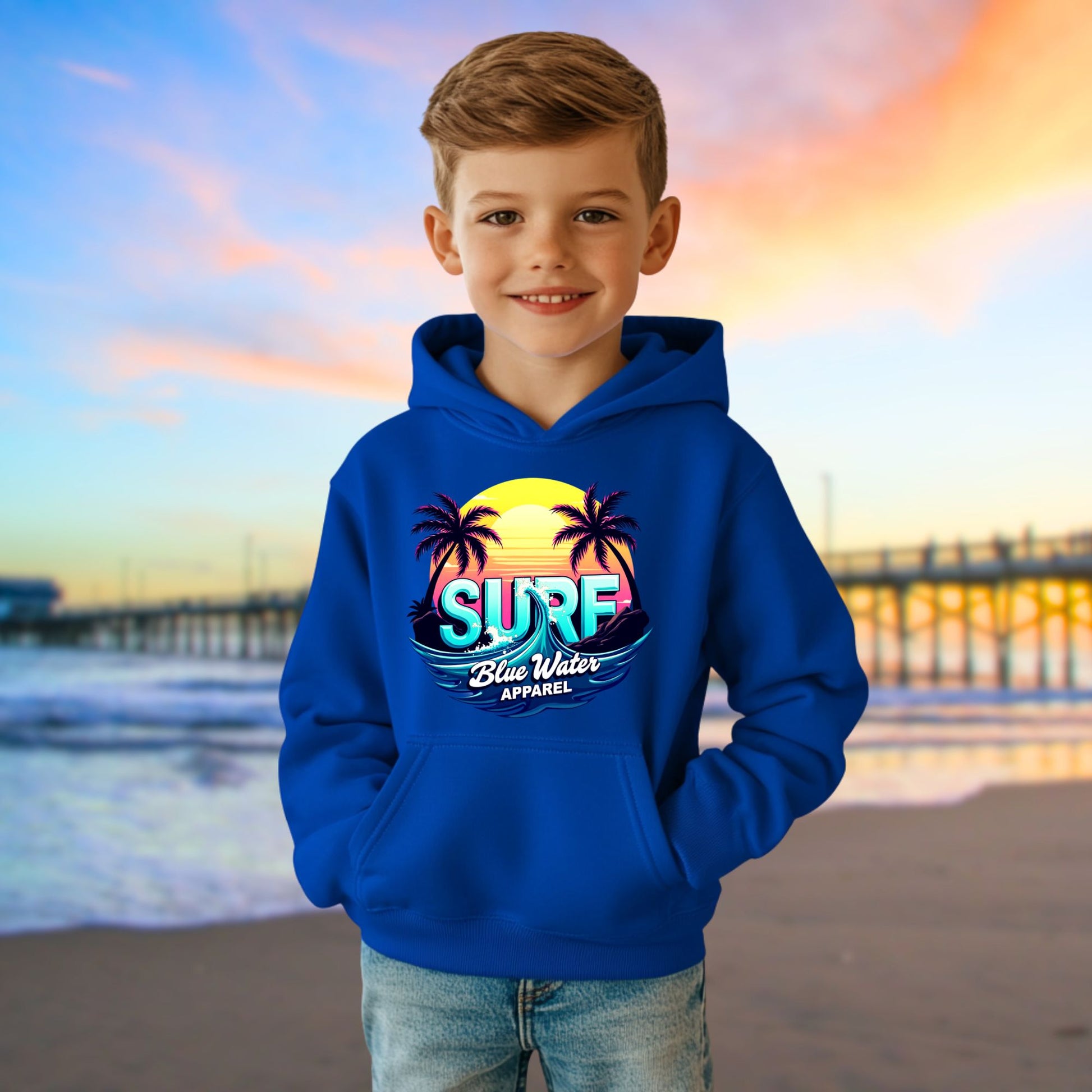 child model on beach wearing royal retro surf kids hoodie by blue water apparel