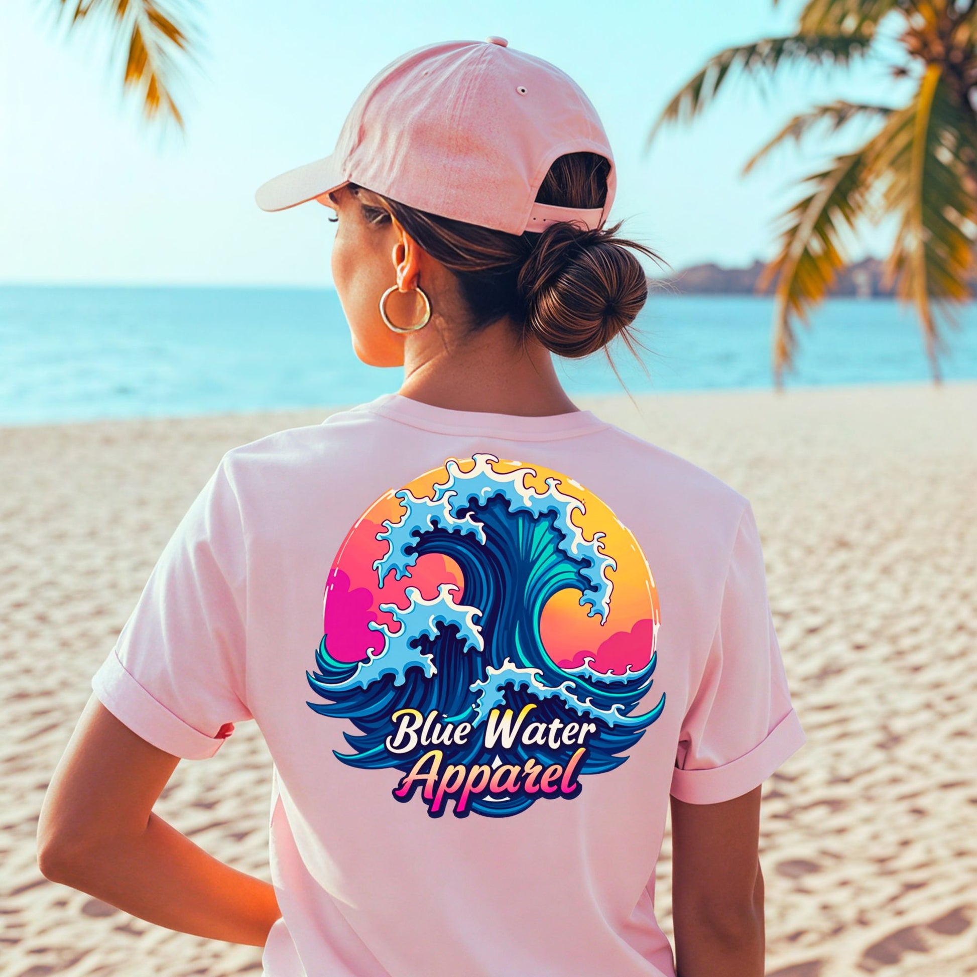 model on beach wearing pink retro wave tee by blue water apparel