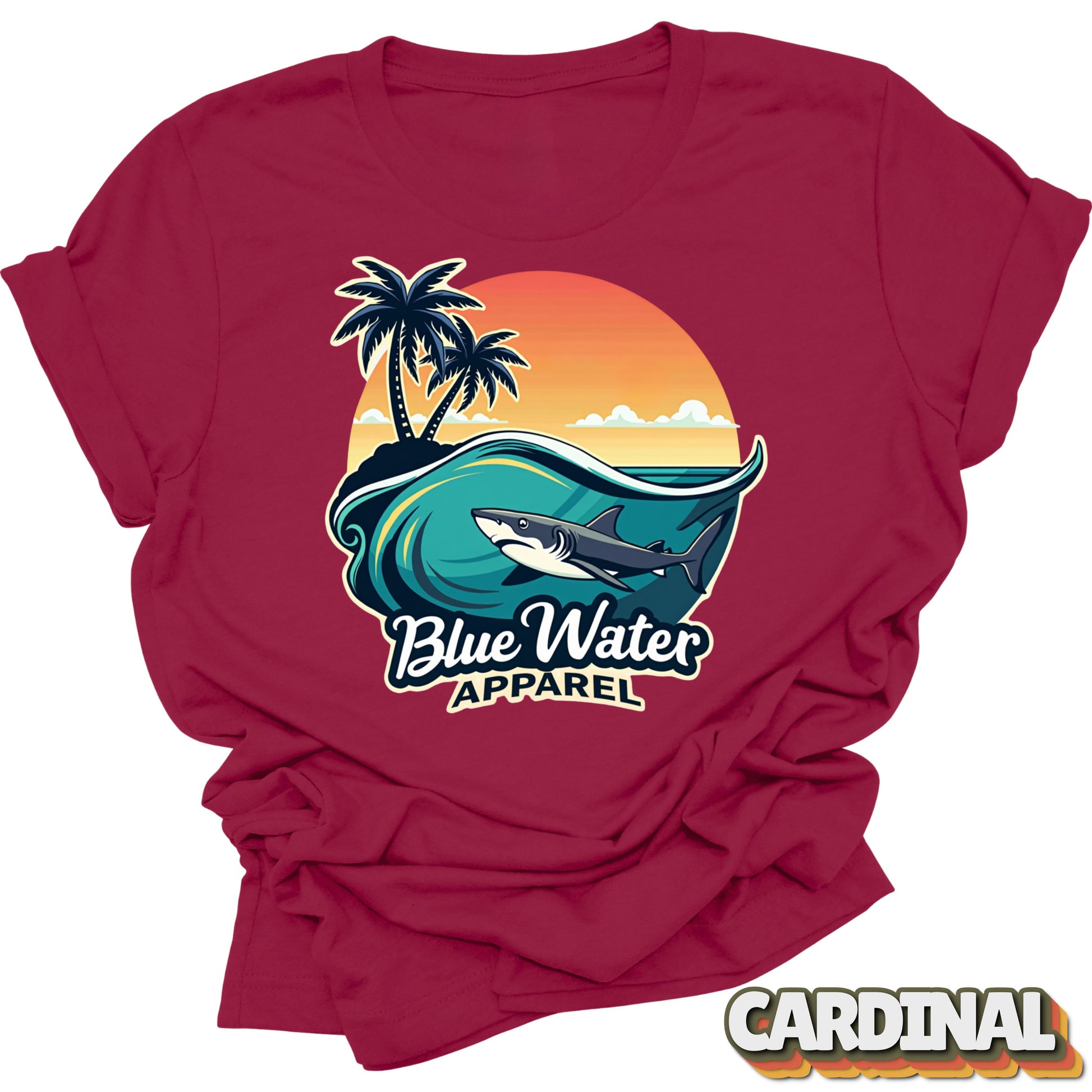 cardinal tee with a graphic of a shark, waves, and palm trees on a 'Blue Water Apparel' design.