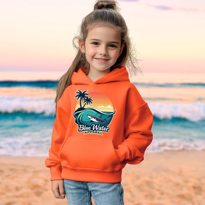 child model on beach wearing orange shark wave kids hoodie by blue water apparel
