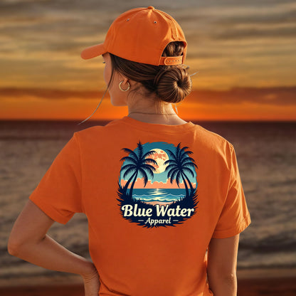 model on beach wearing orange tropical moon tee by blue water apparel