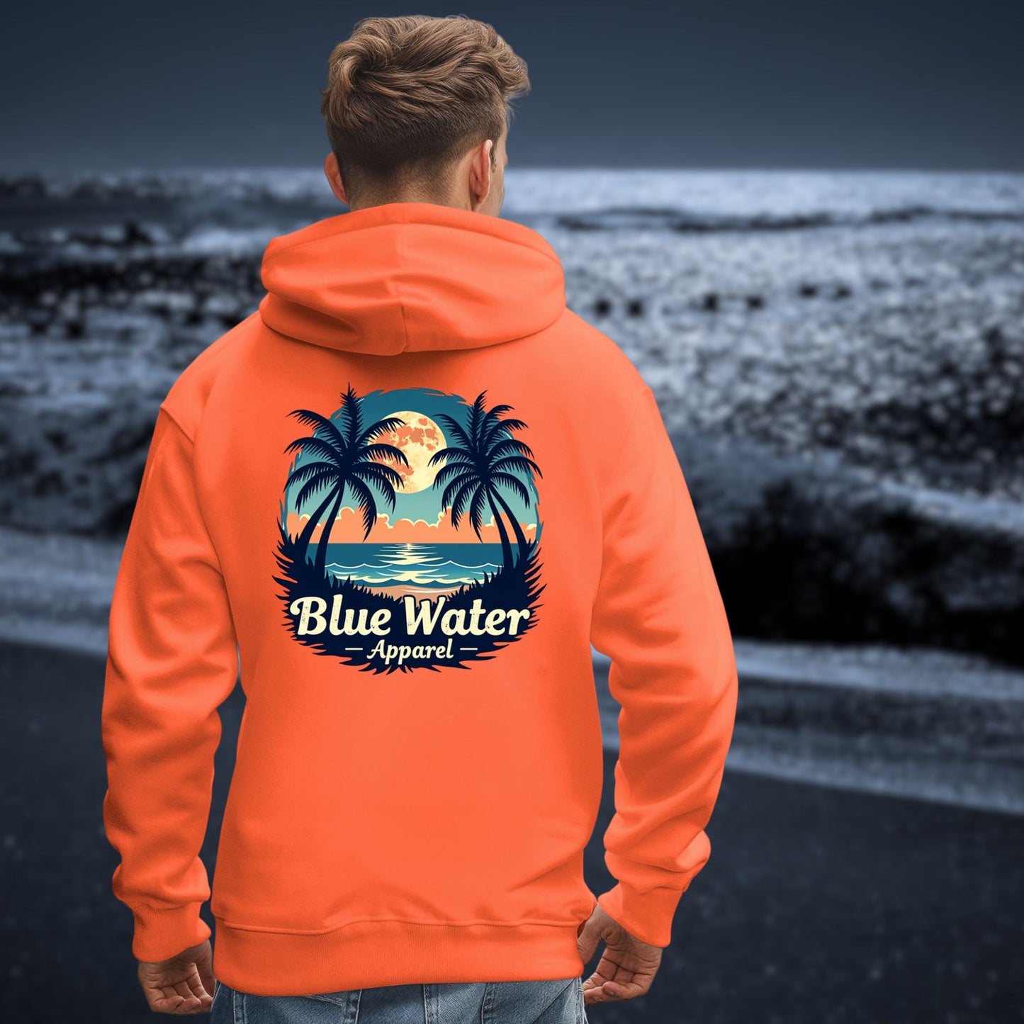 model on moonlit beach wearing orange tropical moon hoodie by blue water apparel