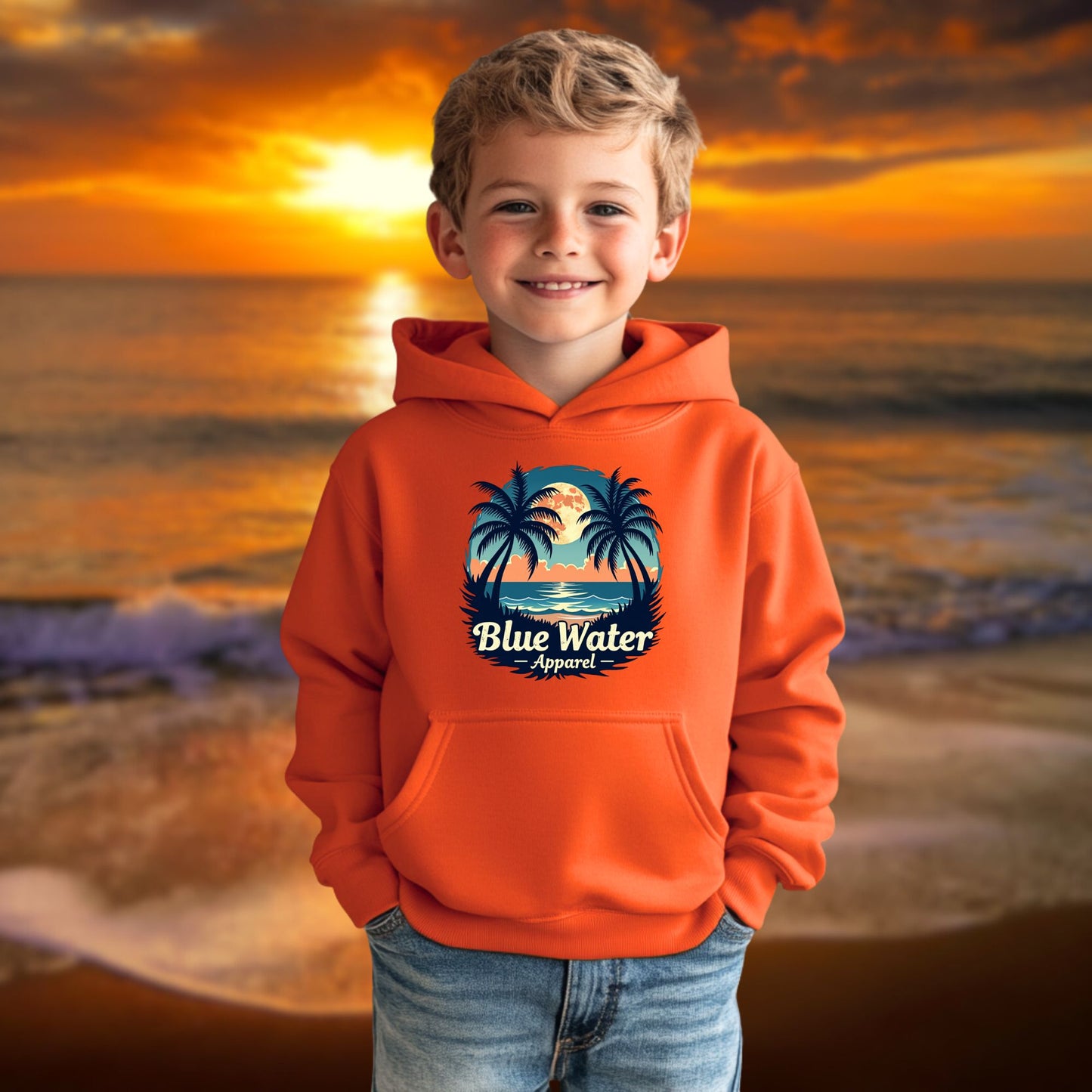 child model on beach wearing orange tropical moon kids hoodie by blue water apparel