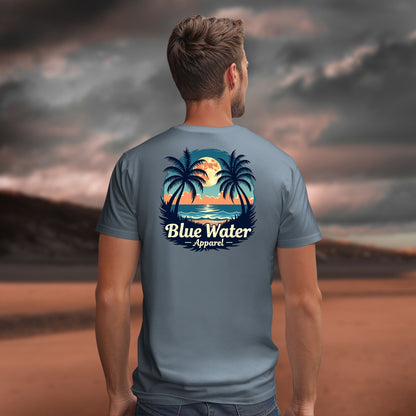 male model looking over ocean wearing steel blue tropical moon tee by blue water apparel