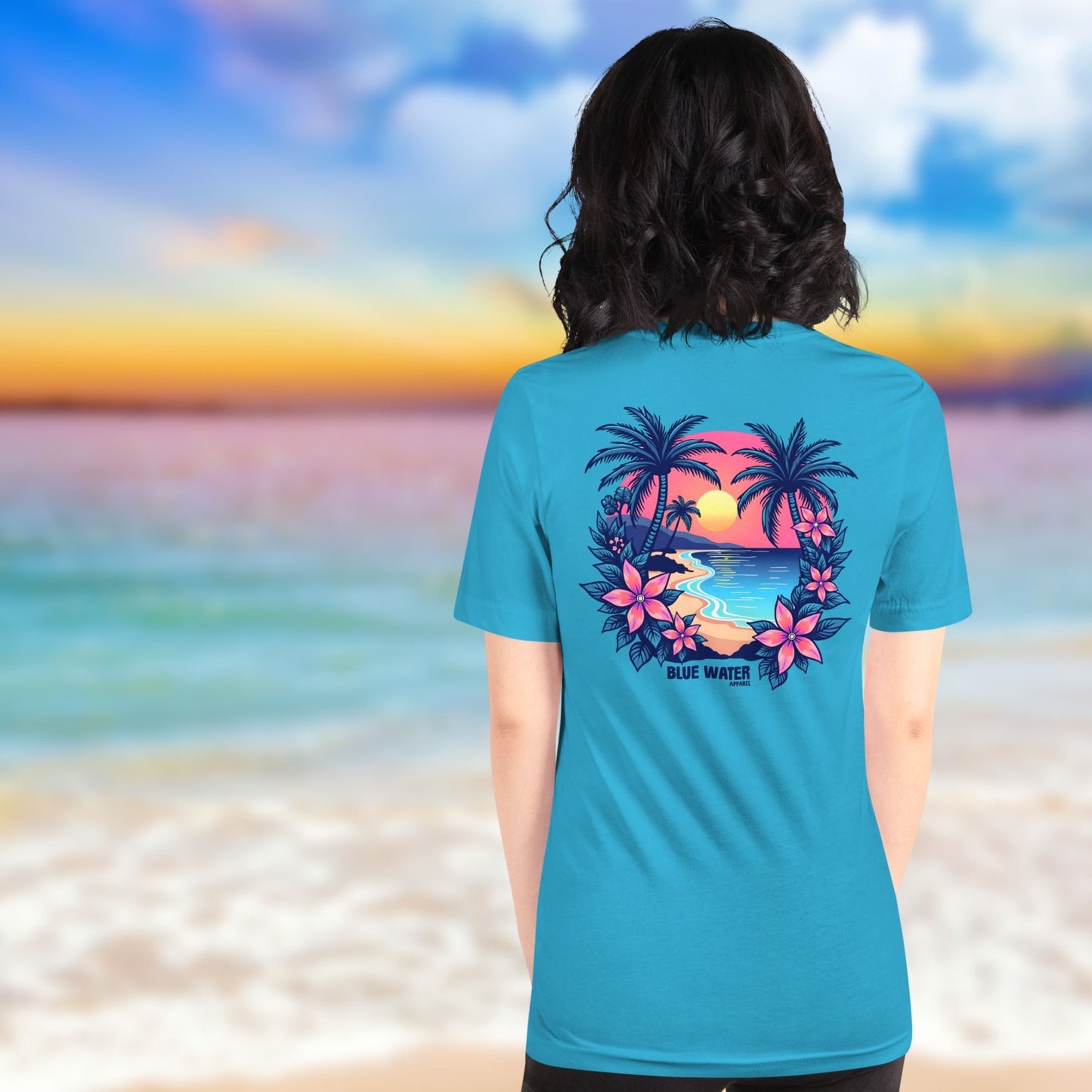 female model on beach wearing aqua tropical sunset tee by blue water apparel