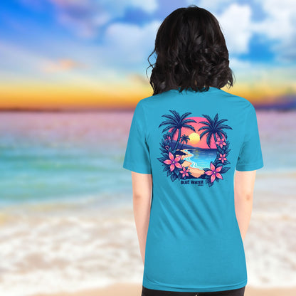 female model on beach wearing aqua tropical sunset tee by blue water apparel