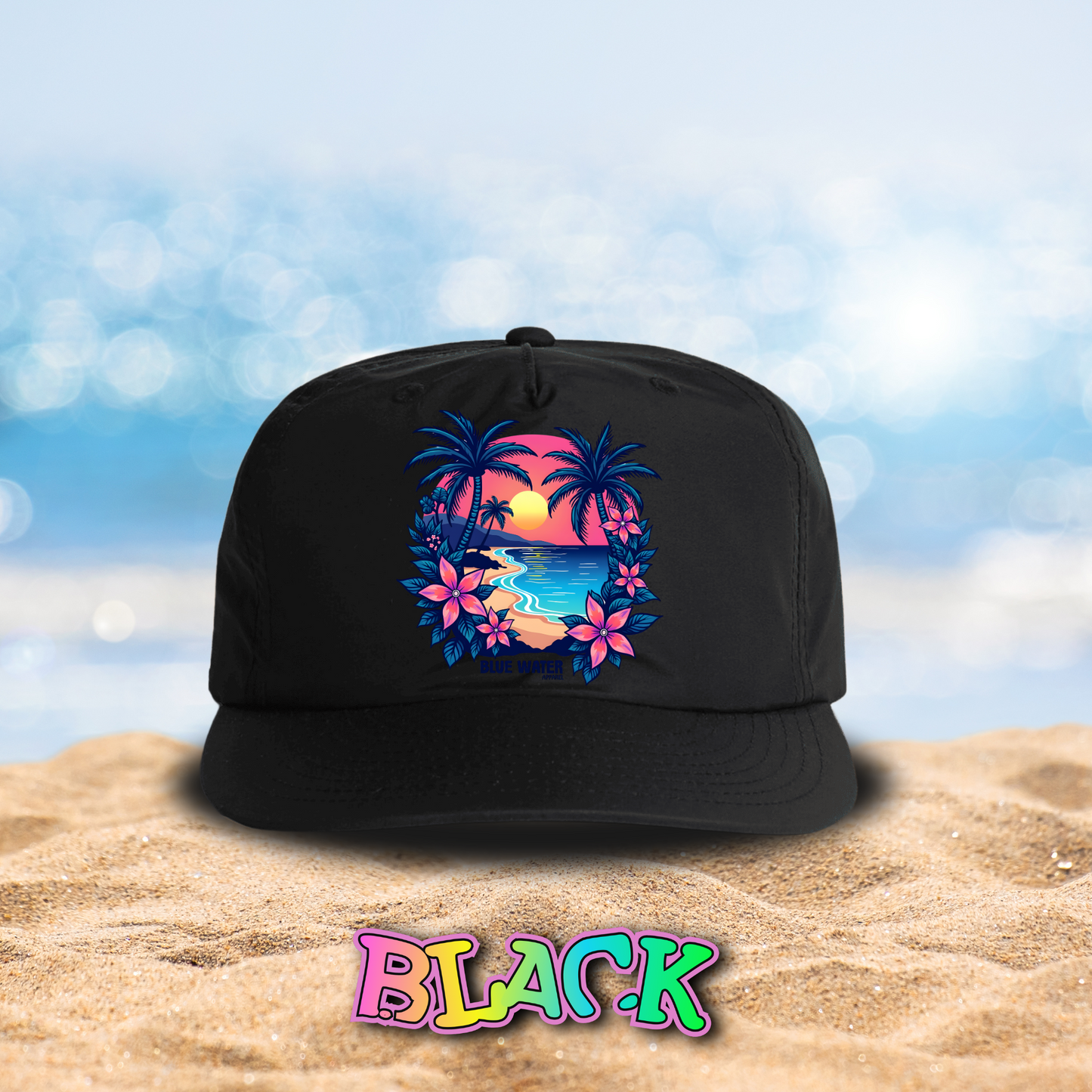 flat lay black tropical sunset surf cap on beach by blue water apparel