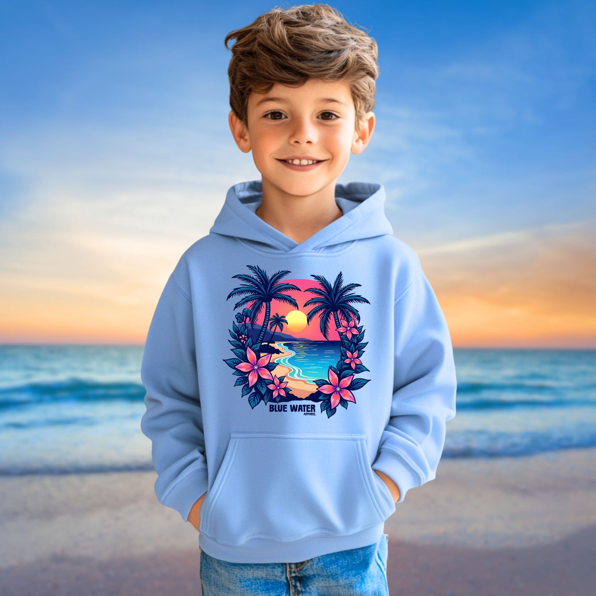 male model on beach wearing carolina blue tropical sunset kids hoodie by blue water apparel