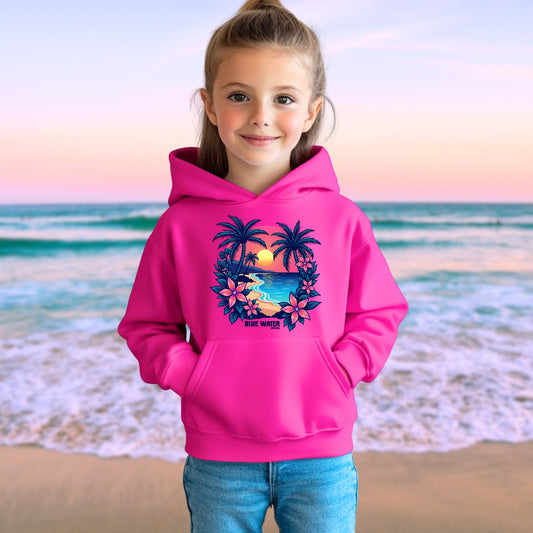 female model on beach wearing heliconia tropical sunset kids hoodie by blue water apparel