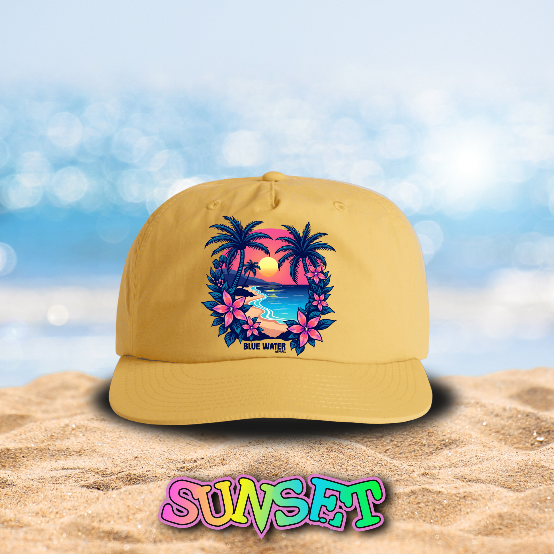 flat lay sunset tropical sunset surf cap on beach by blue water apparel