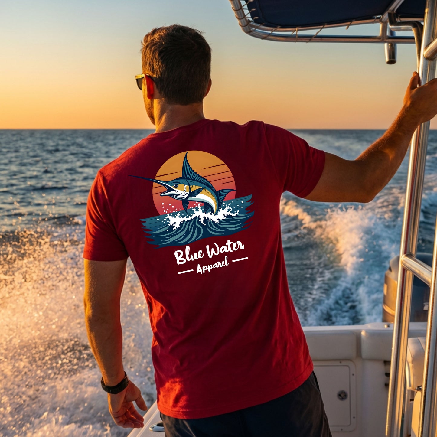 man wearing cardinal vintage marlin tee on chartered fishing boat by blue water apparel