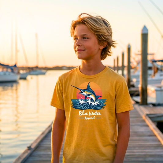 kid wearing gold vintage marlin kids tee on boat dock by blue water apparel