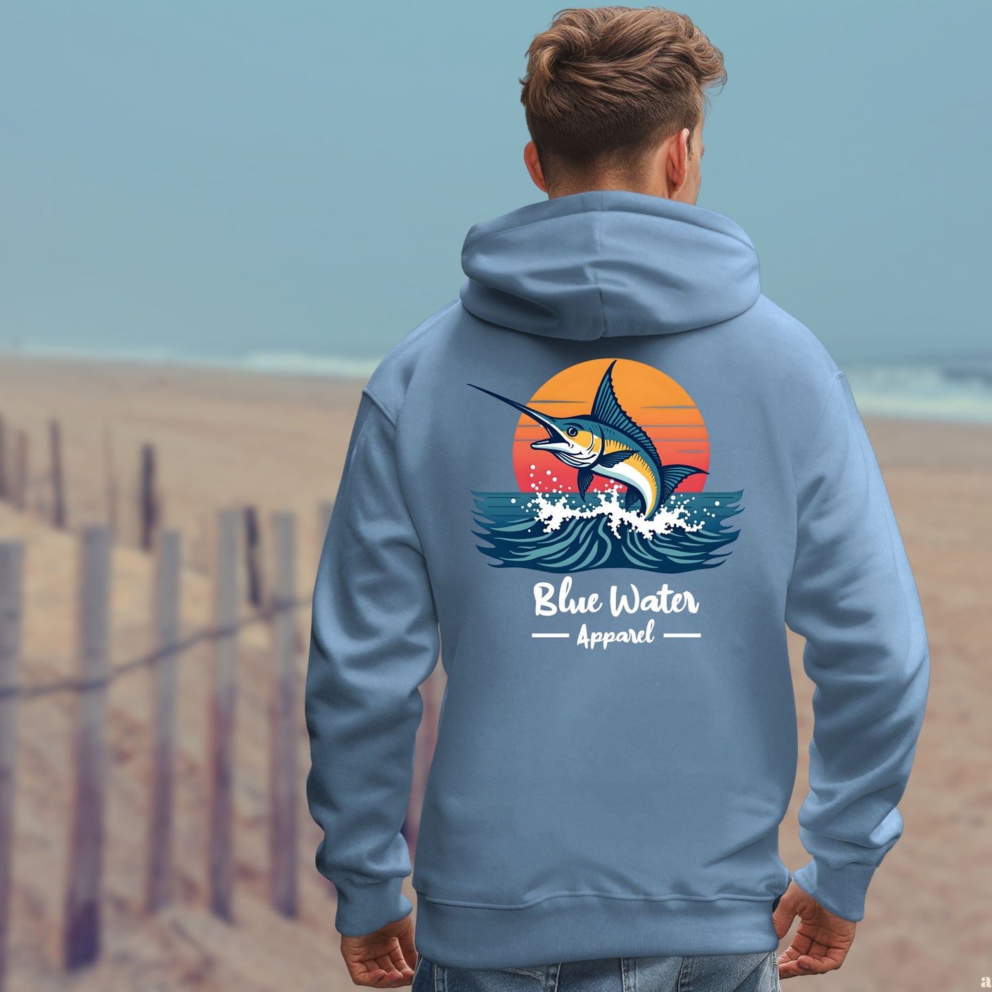 model on beach wearing indigo blue vintage marlin hoodie by blue water apparel